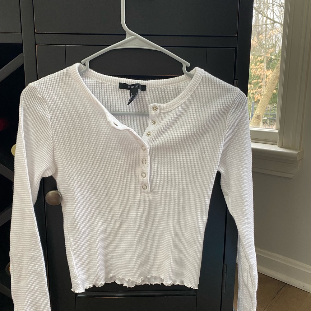Forever 21 white ribbed button up shirt. Long sleeved. Detailed at the bottom.